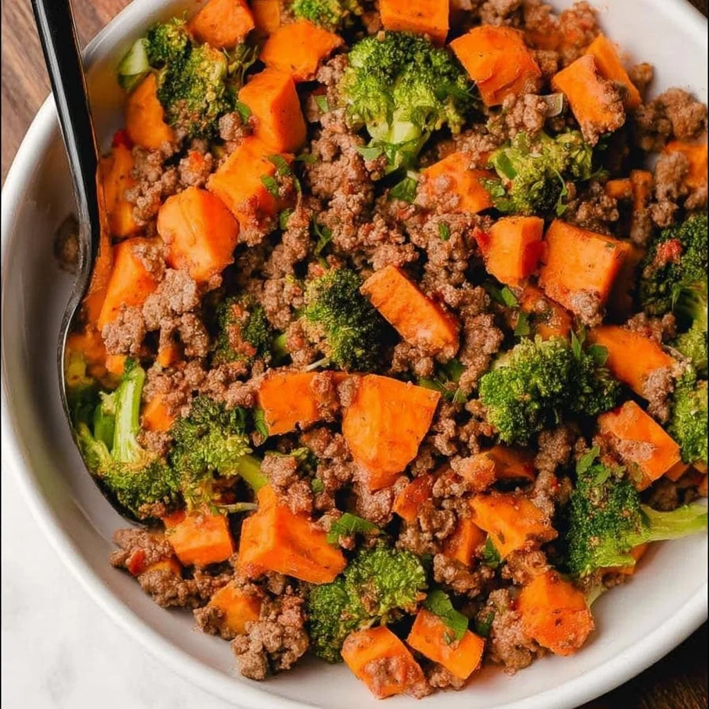 Ground beef and sweet potatoes dish on a plate garnished with herbs