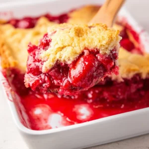 Delicious Easy Strawberry Dump Cake served on a plate with strawberries