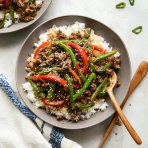 Colorful ground beef stir fry with vegetables in a skillet