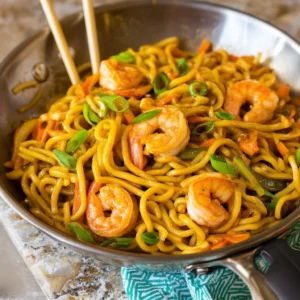 Delicious shrimp lo mein served in a bowl with colorful vegetables and noodles
