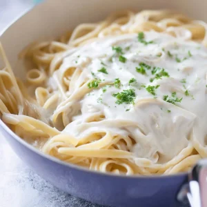 Bowl of creamy homemade Alfredo sauce with fettuccine pasta