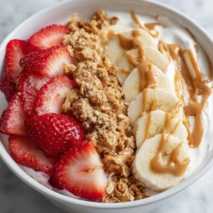 Strawberry Banana Peanut Butter Yogurt Bowl with fresh fruits and nuts