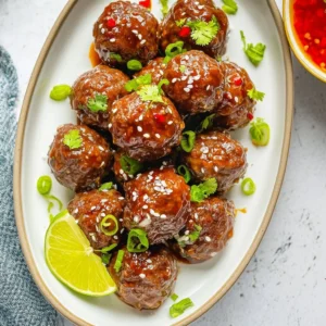 Delicious teriyaki meatballs drizzled with sauce and served with rice.