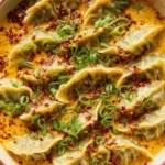Baked potstickers served with Thai curry sauce on a plate