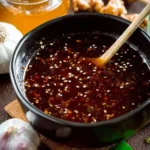 Homemade teriyaki sauce in a bowl with ingredients, showcasing a healthy recipe option.