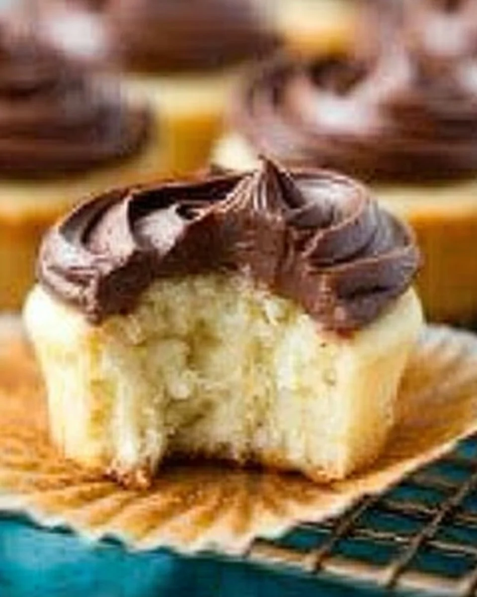 Delicious Boston Cream Pie cupcakes with chocolate icing and cream filling