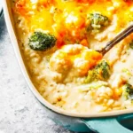 Creamy broccoli rice casserole topped with cheese in a baking dish