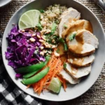 Delicious chicken quinoa bowl with vegetables and dressing