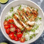 Healthy cilantro lime chicken rice bowl with fresh vegetables