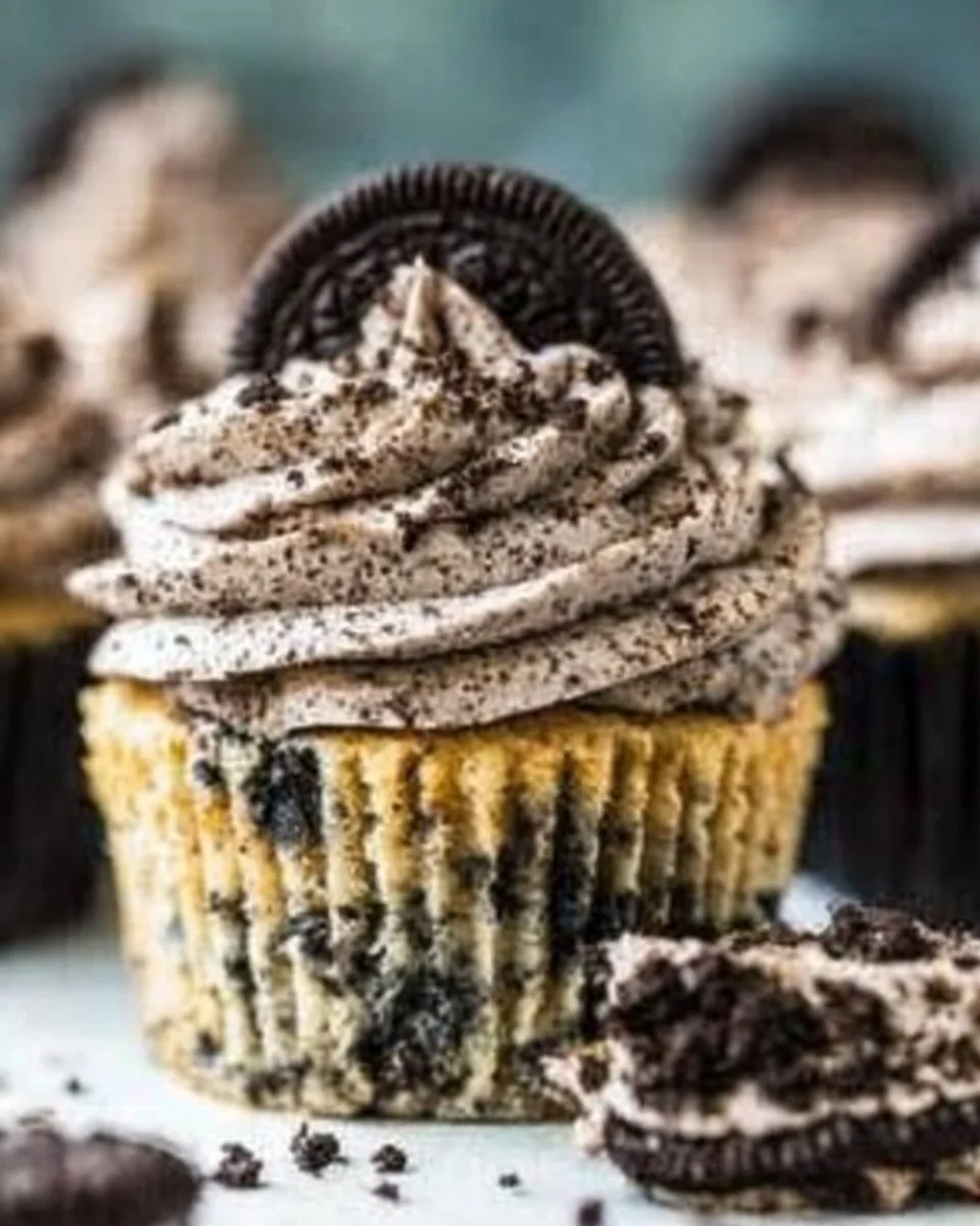 Delicious Cookies and Cream Cupcakes topped with cream and cookie crumbs