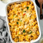 Creamy ground turkey pasta bake topped with cheese in a casserole dish