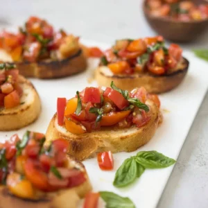 Fresh tomato bruschetta garnished with balsamic reduction on toasted bread