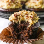 Delicious German chocolate cupcakes with coconut pecan frosting on a plate.
