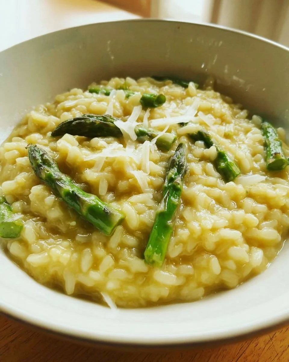 Creamy Lemon Asparagus Risotto dish garnished with fresh asparagus and lemon zest.