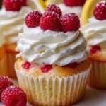 Moist lemon cupcakes with raspberry filling on a beautiful serving plate