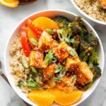 Delicious orange ginger salmon bowls garnished with fresh vegetables