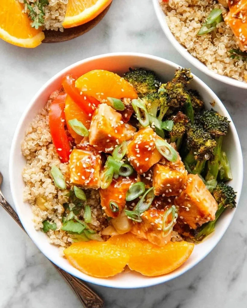 Delicious orange ginger salmon bowls garnished with fresh vegetables