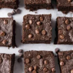Delicious homemade protein brownies topped with chocolate and nuts.