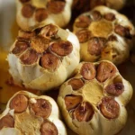 Creamy roasted garlic served in a bowl, perfect for a heart-healthy dish.