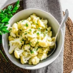 Healthy steamed cauliflower with herbs on a plate