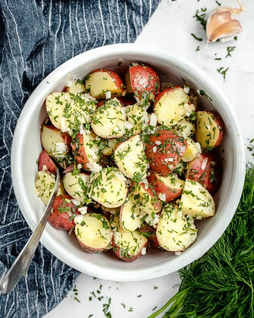 Bowl of simple steamed potatoes with herbs, a healthy meal option for families.