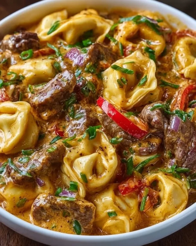 Creamy cheesesteak tortellini prepared in a slow cooker for busy families