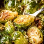 Slow Cooker Parmesan Brussels Sprouts in a creamy sauce, served in a bowl