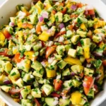Hearty avocado salsa bowl topped with fresh ingredients and served with tortilla chips.