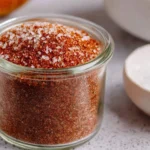 Homemade brisket rub seasoning on a cutting board with spices.