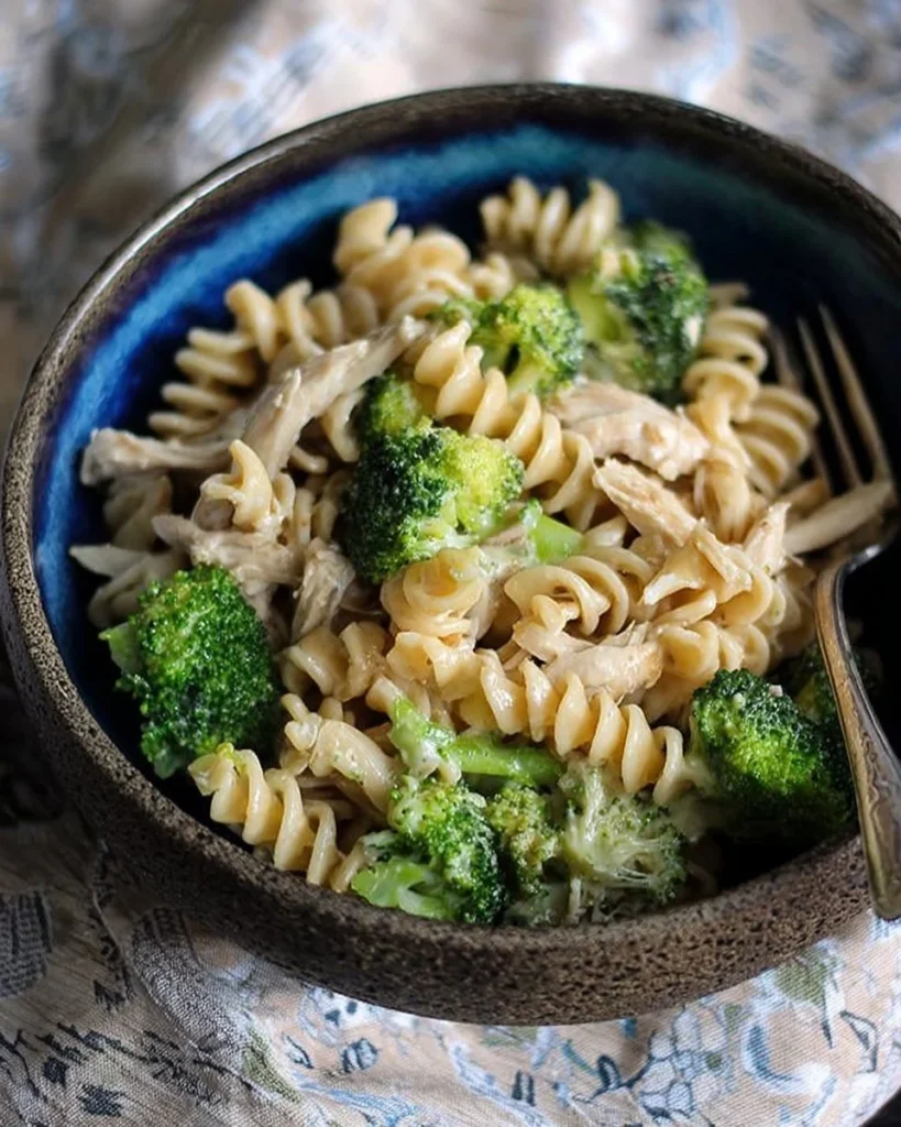 Cheesy chicken and broccoli pasta dish served in a bowl