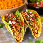Plate of Chicken Tinga served with tortillas and garnished with avocado