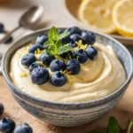 Delicious cottage cheese lemon mousse in a glass, topped with lemon zest.