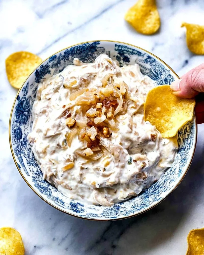 Creamy French onion dip served with fresh vegetables and chips.