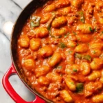 Plate of gnocchi served with vibrant tomato sauce and fresh basil