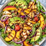 Delicious grilled peach salad with greens and dressing