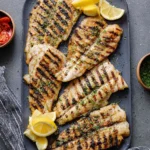 Delicious grilled tilapia served with fresh vegetables on a plate