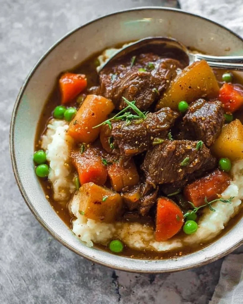 Instant Pot beef stew in a bowl with vegetables and herbs