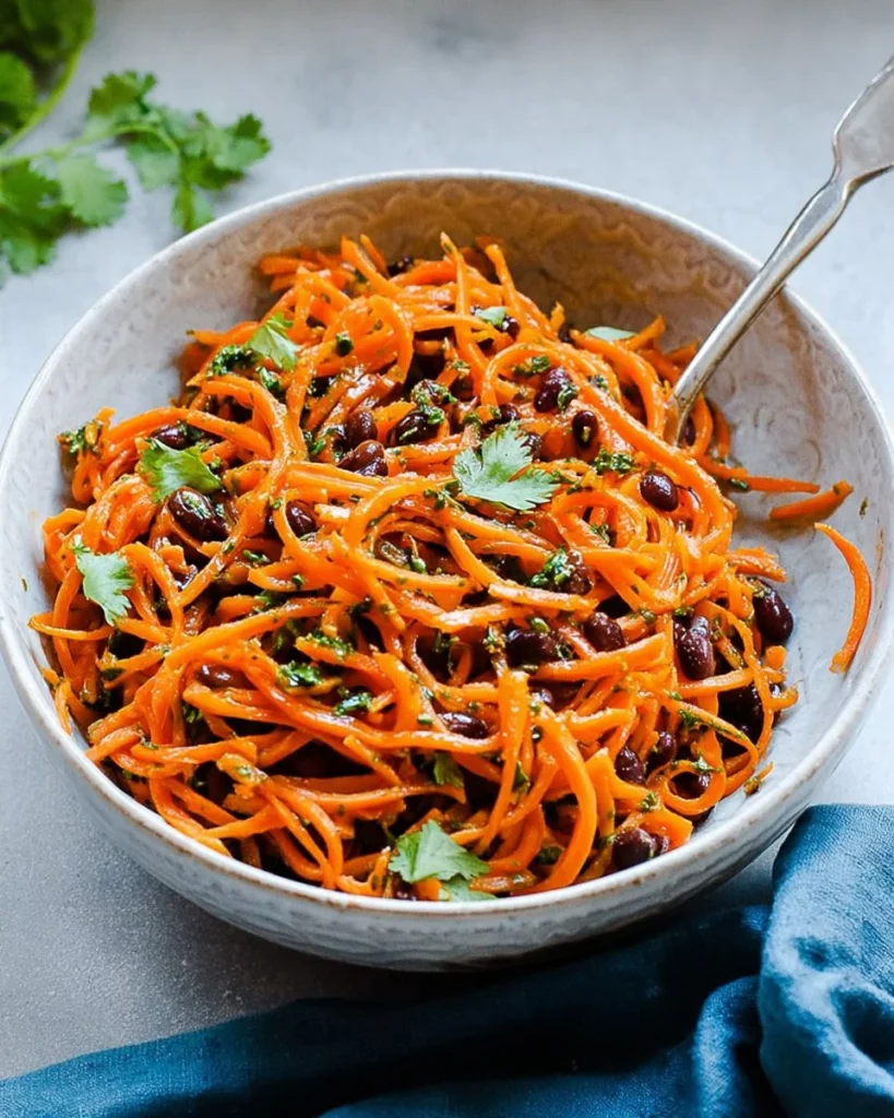 Delicious Moroccan Carrot Salad garnished with herbs and spices.