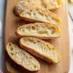 Freshly baked no knead bread loaf on a wooden cutting board