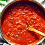 Delicious penne pasta with marinara sauce garnished with fresh basil