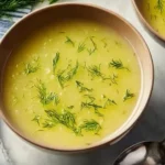 Bowl of creamy potato leek soup garnished with fresh chives