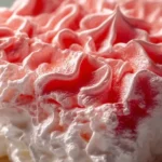 Bowl of creamy Rhubarb Fluff dessert topped with fresh rhubarb