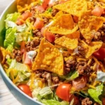 A colorful serving of Simple Doritos Taco Salad topped with crunchy Doritos.