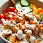 Sriracha Ranch Chicken Bowl topped with fresh ingredients and spicy sauce.