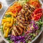 Delicious Thai Chicken Mango Salad with fresh mango slices and grilled chicken.