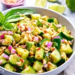 Bowl of Thai cucumber salad with vibrant vegetables and dressing