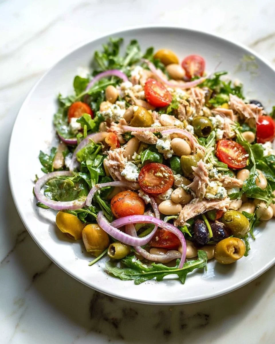 Tuscan Tuna and White Bean Salad garnished with fresh herbs, a healthy meal option.