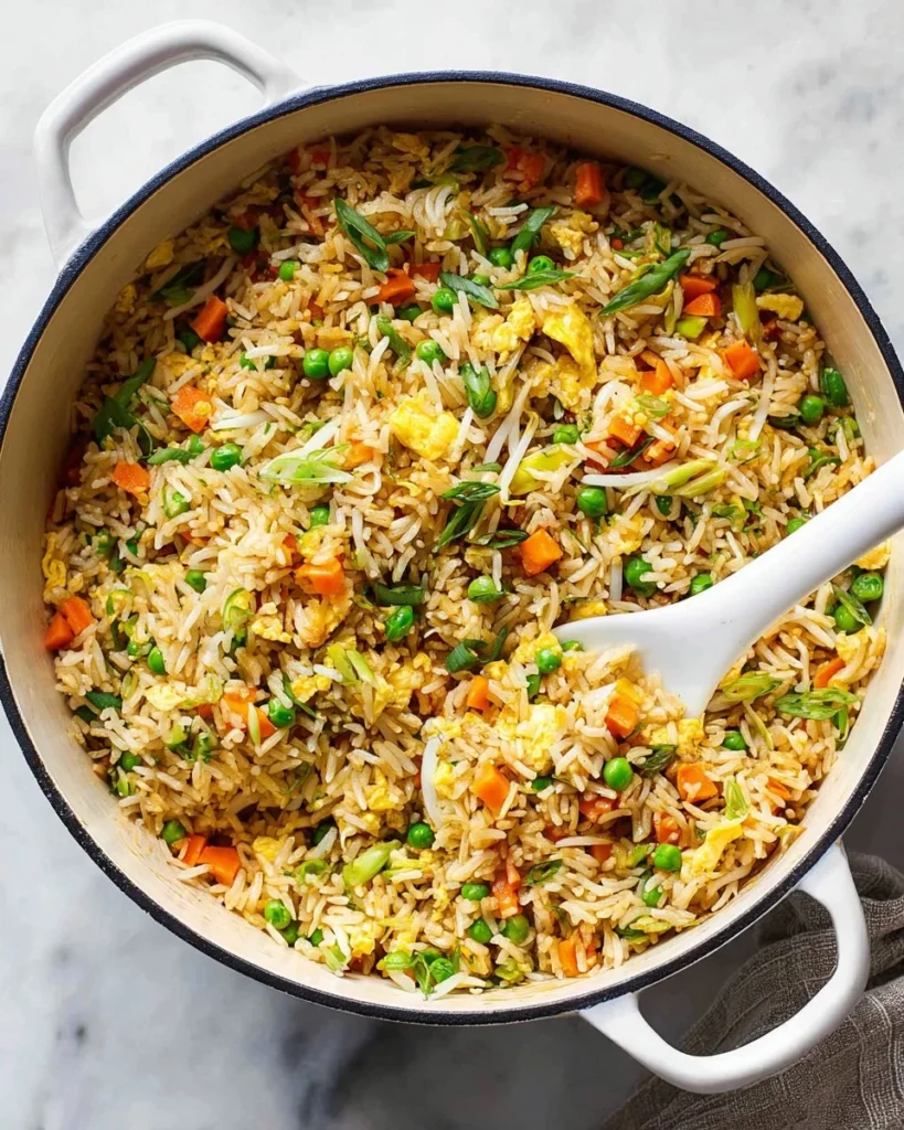 Colorful bowl of Vegetable Fried Rice with fresh vegetables and herbs.