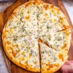Creamy and protein-packed white pizza topped with fresh ingredients.