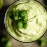 Creamy avocado lime dressing drizzled over a fresh salad.